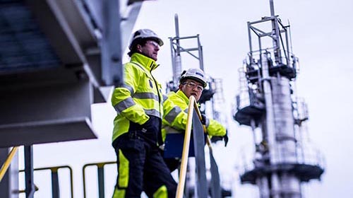 oil refinery workers discussing outside